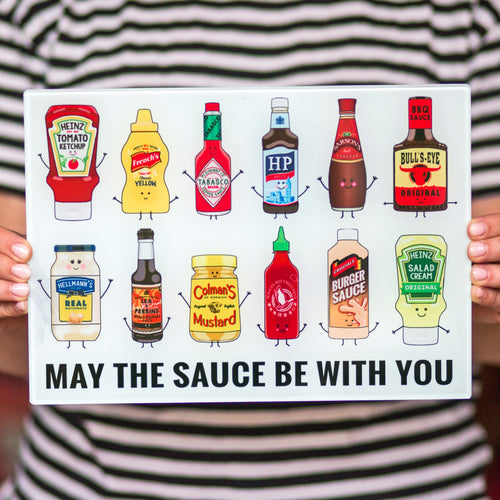 funny glass chopping board with illustrations of sauces and a funny pun