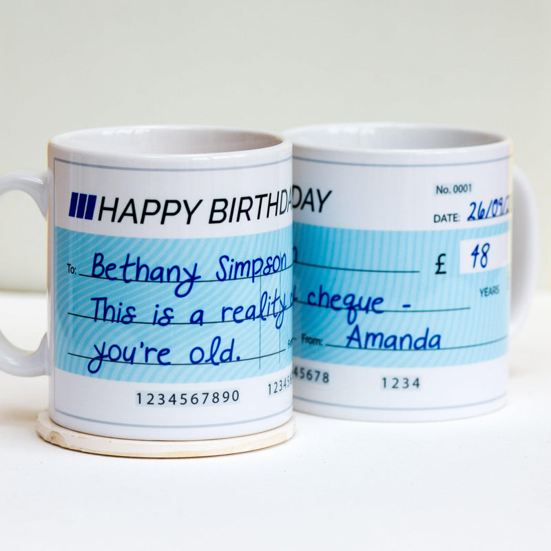 Personalised Reality Cheque Birthday Mug: A humorous ceramic mug with custom details.