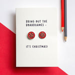 christmas card with darts pun and darts themed cufflinks attached