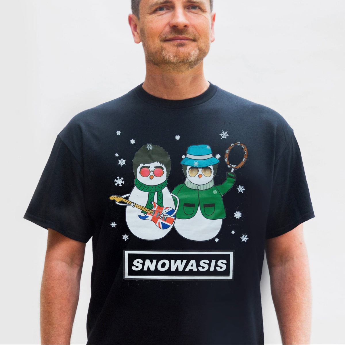 Man wearing a black t-shirt with snowman graphics and 'SNOWASIS' text against a white background