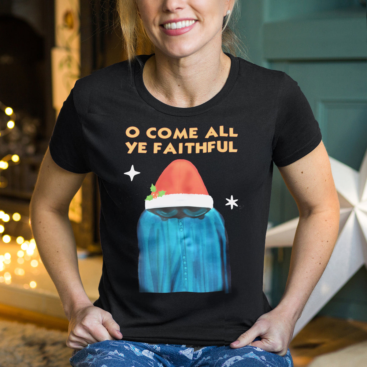 Lady wearing a black t-shirt with Christmas-themed Traitors design and text.