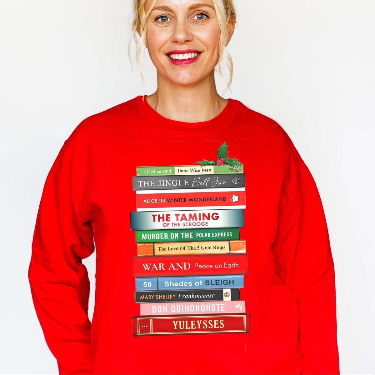 Person wearing a red christmas sweatshirt with book design on a white background