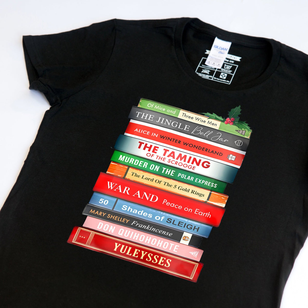 Black christmas t-shirt with colorful book stack design on a white background