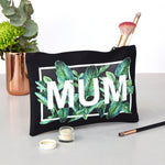 black wash bag with tropical leaf design and the word mum
