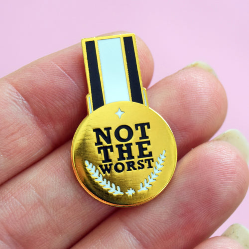 funny enamel pin badge designed to look like a medal that says 'Not The Worst'