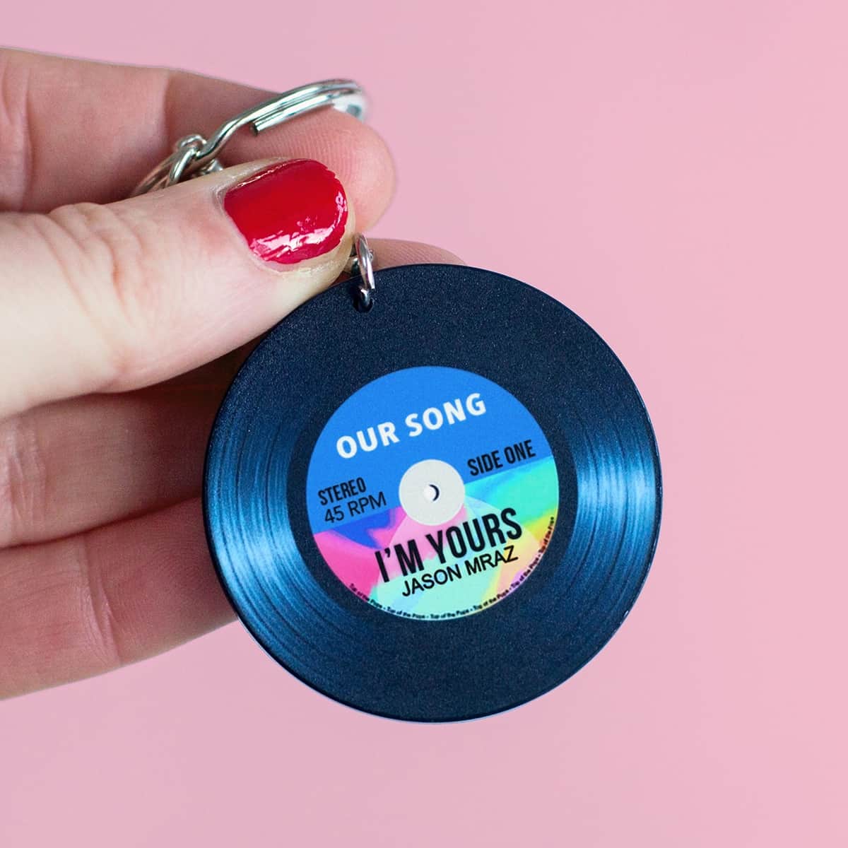 a personalised keyring designed to look like a vinyl record personalised with a song