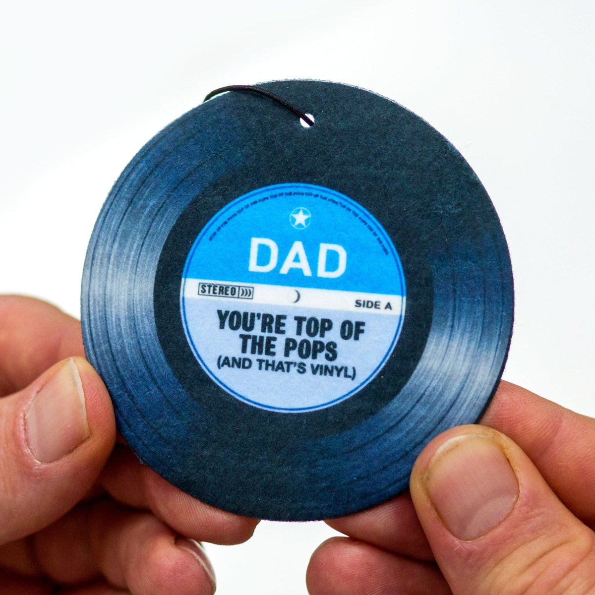 a car air freshener designed to look like a record label saying dad you're top of the pops