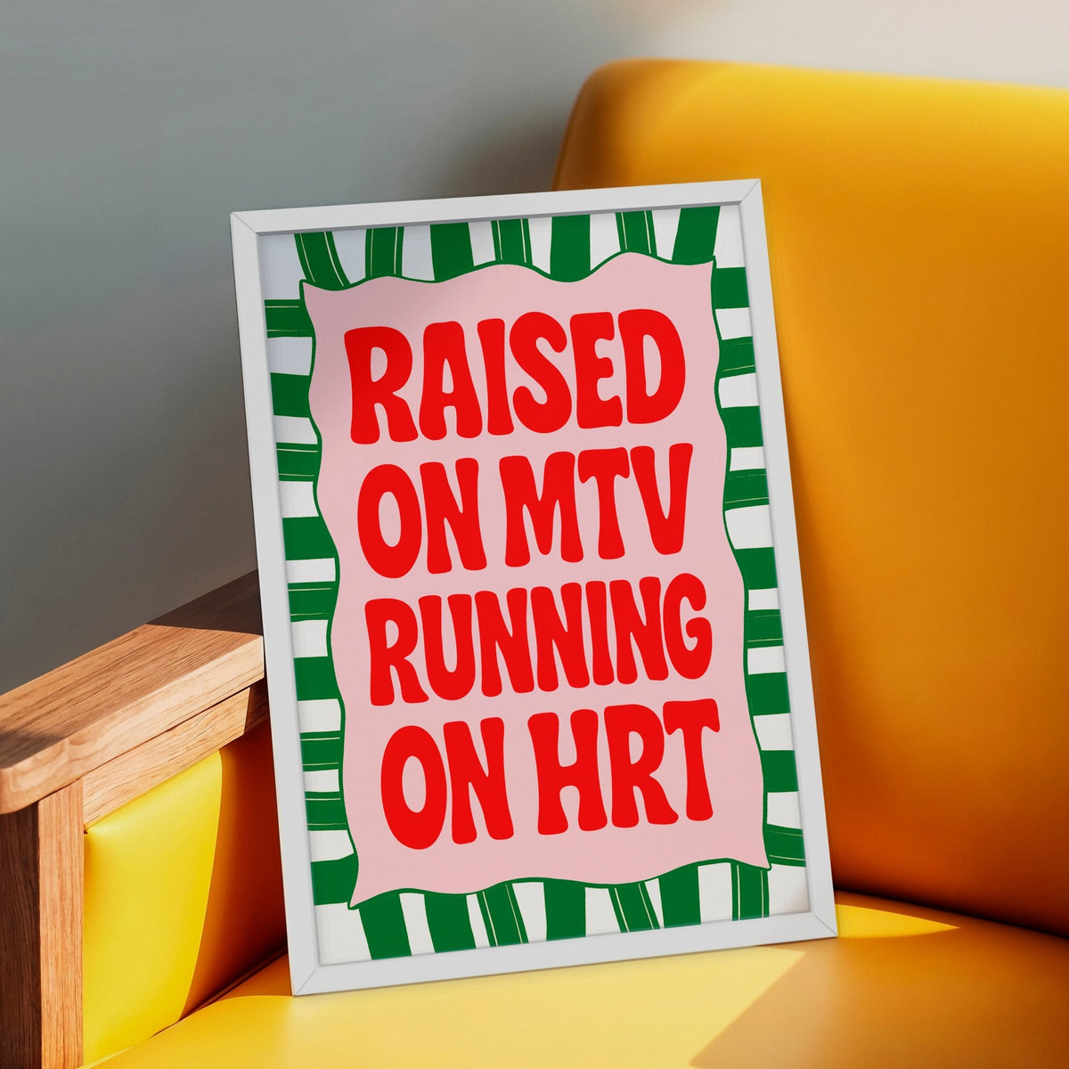 a poster that says raised on MTV running on HRT in a white frame on a yellow armchair