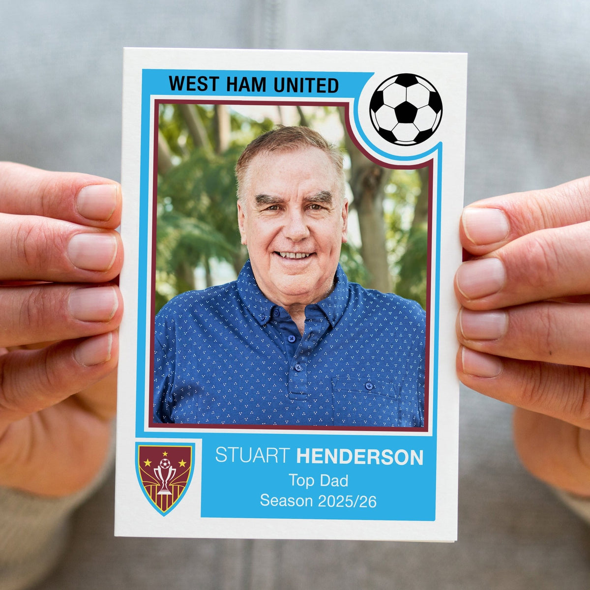 Person holding a greeting card designed to look like a Panini football sticker 