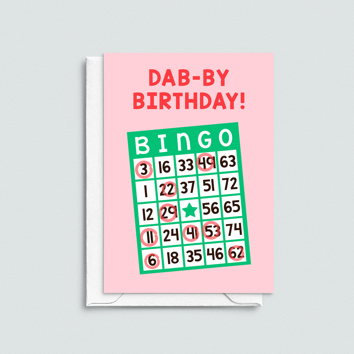bingo card birthday card with pun 'dab-by birthday' with a white envelope on a grey background