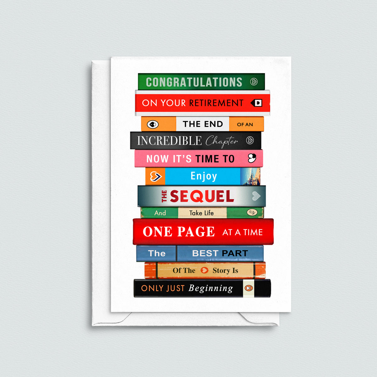 A white greeting card with a stack of colorful book spines printed on the front, featuring retirement-themed phrases like 'Congratulations on your retirement' and 'The End of an Incredible Chapter.' The card is shown standing upright against a light gray background.