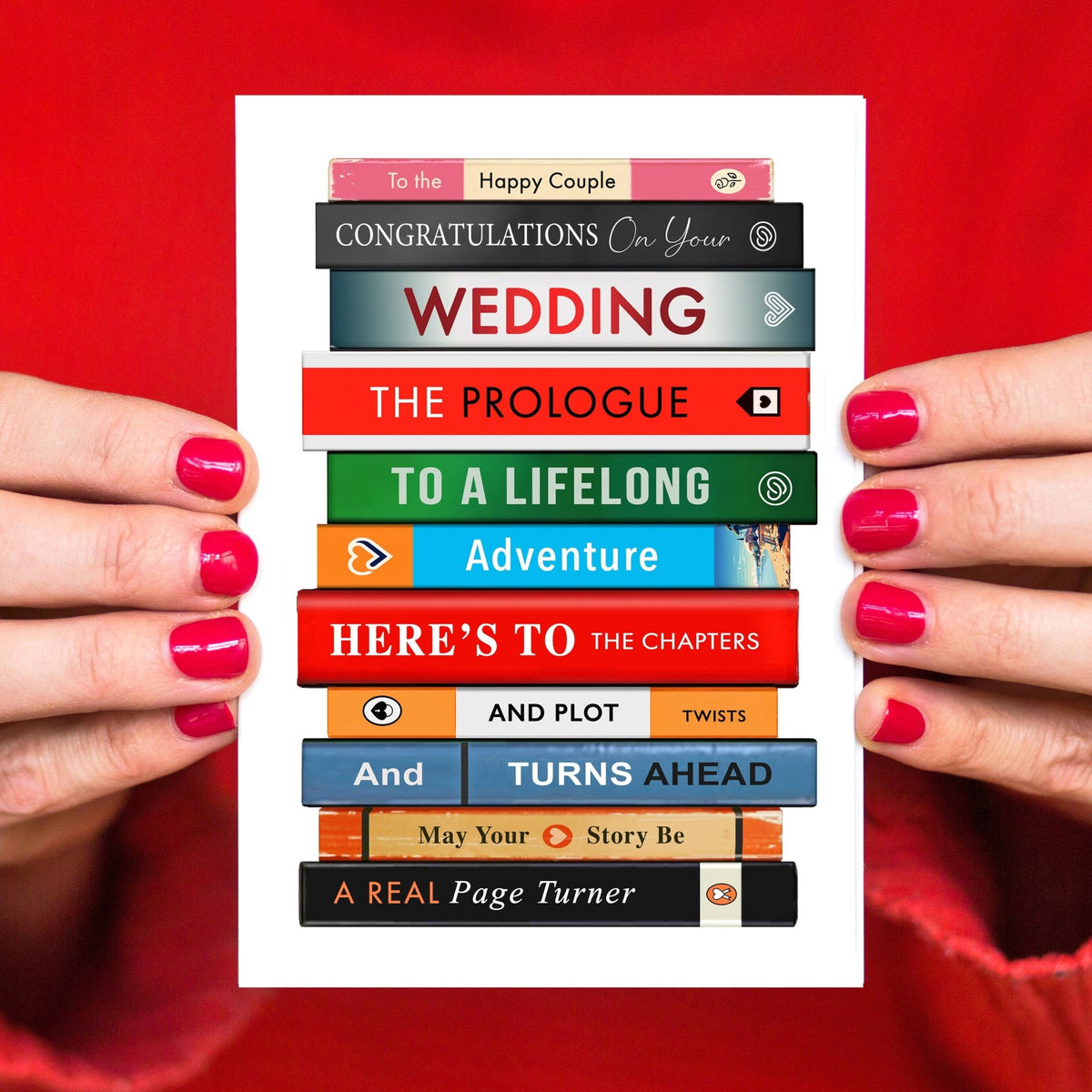 a wedding card featuring a stack of books spelling a congratulations message using literary terms