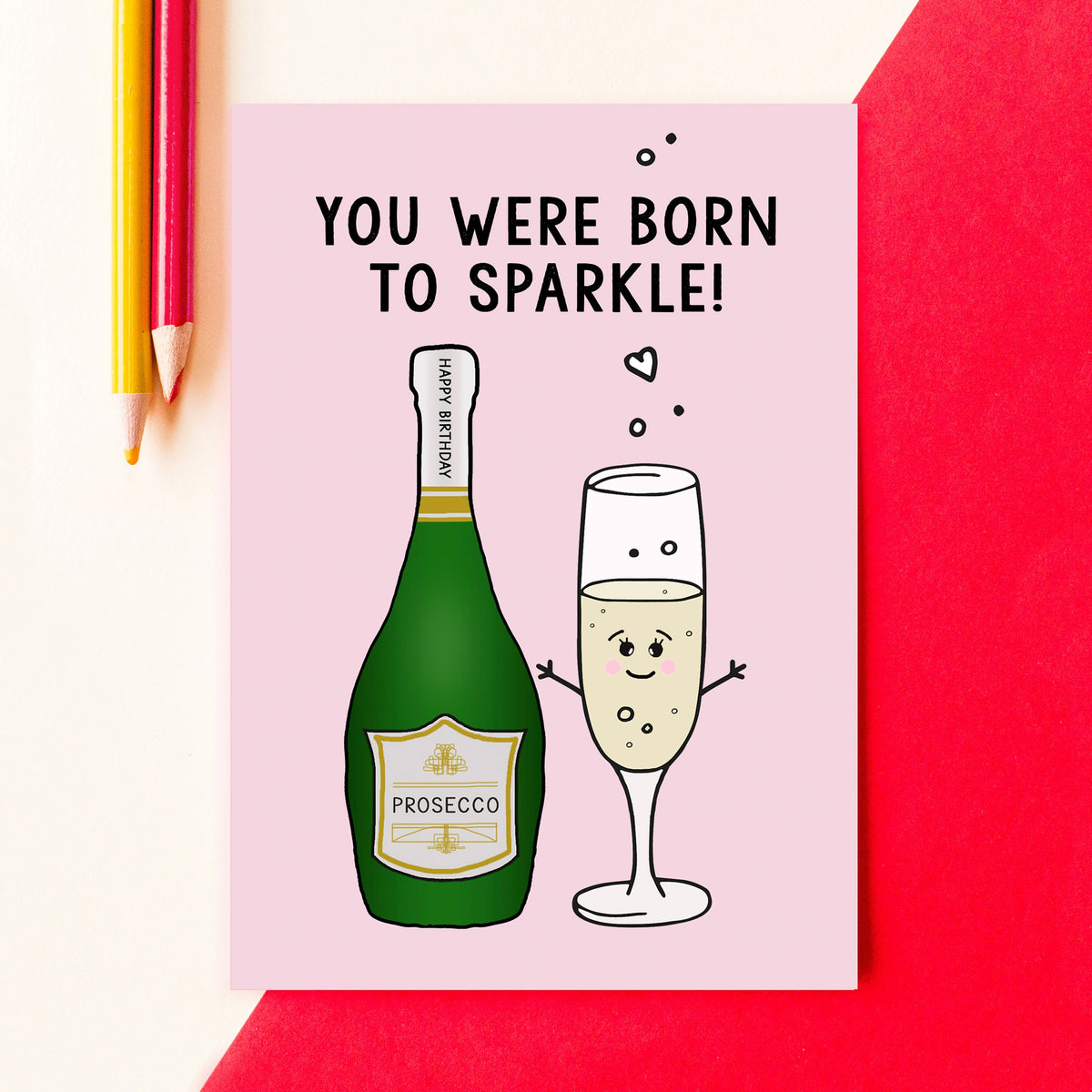 Card with cartoon prosecco bottle and glass on a pink background, with text 'You were born to sparkle'.