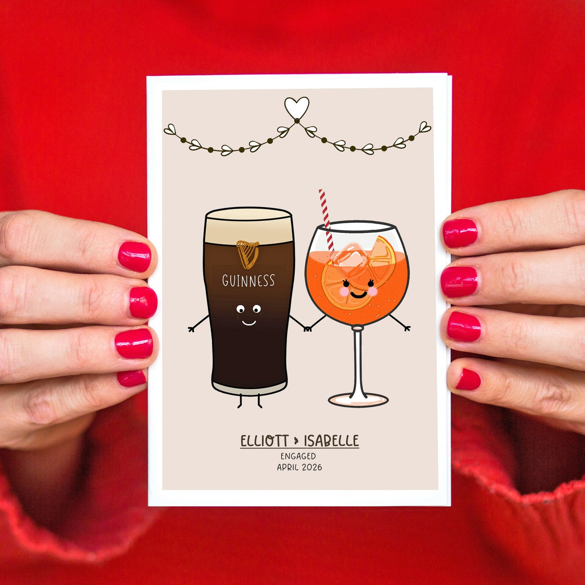 Engagement card with cartoon Guinness and orange juice glasses held by hands against a red background