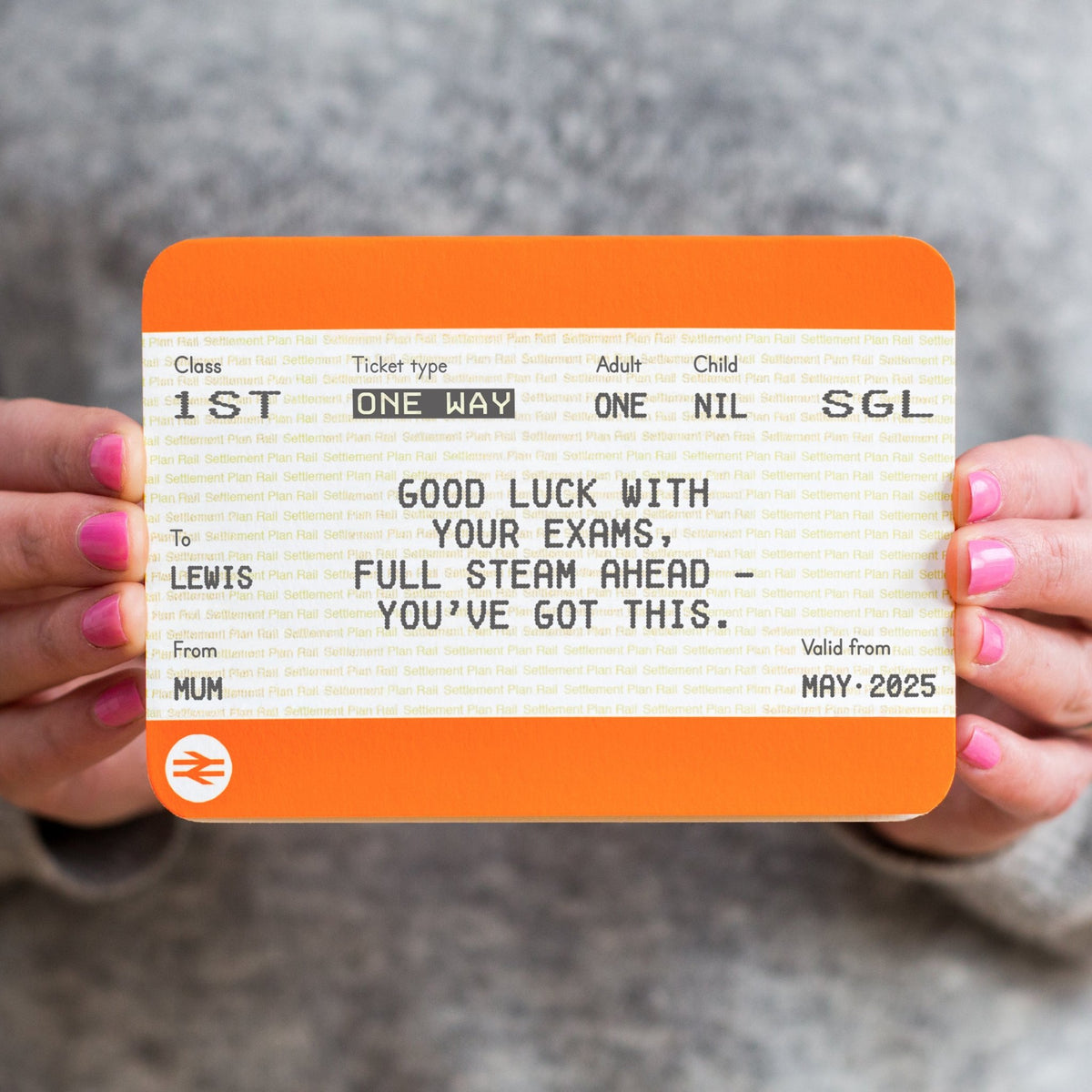 Person holding a personalized train ticket with motivational good luck in exams message