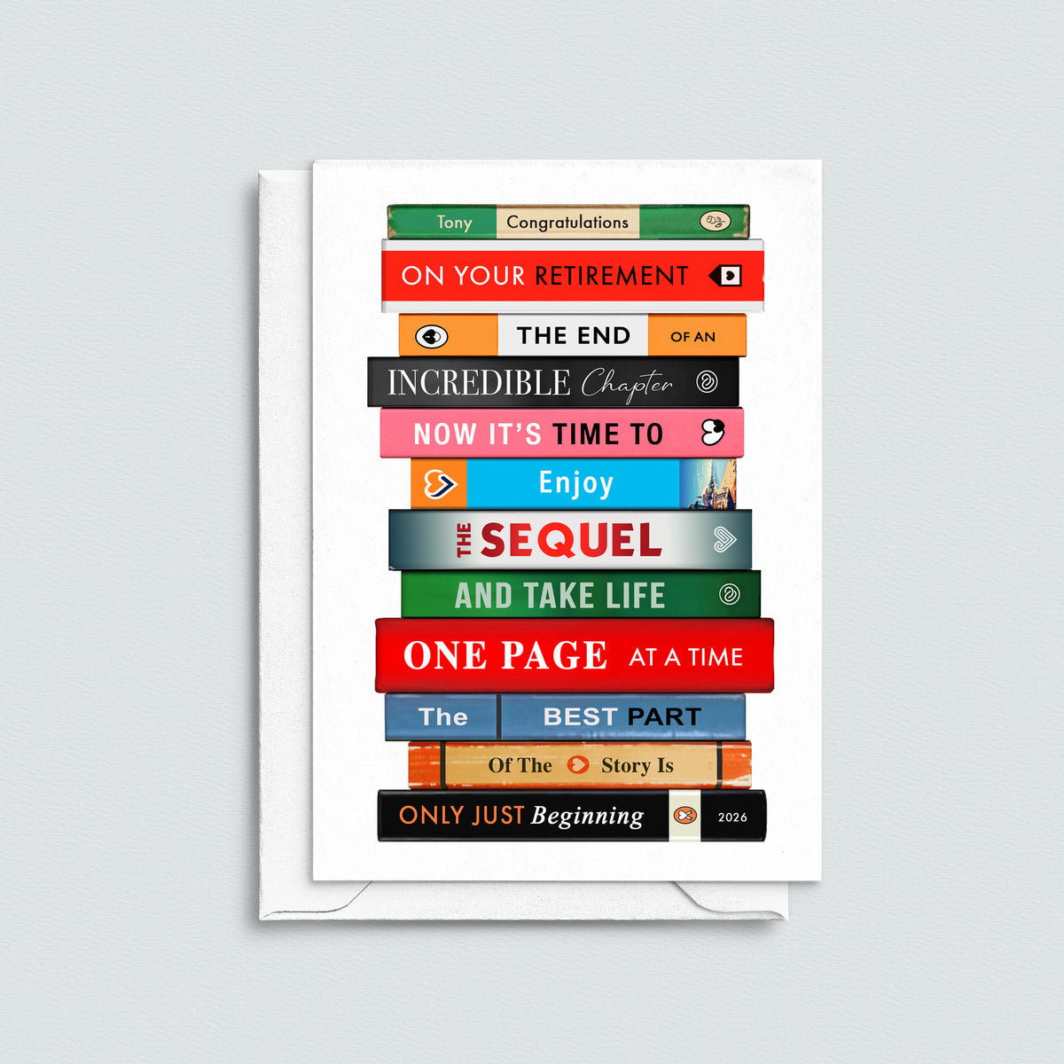 A white retirement card featuring a colourful stack of book spines with book themed retirement quotes, shown with a matching white envelope on a light gray background.