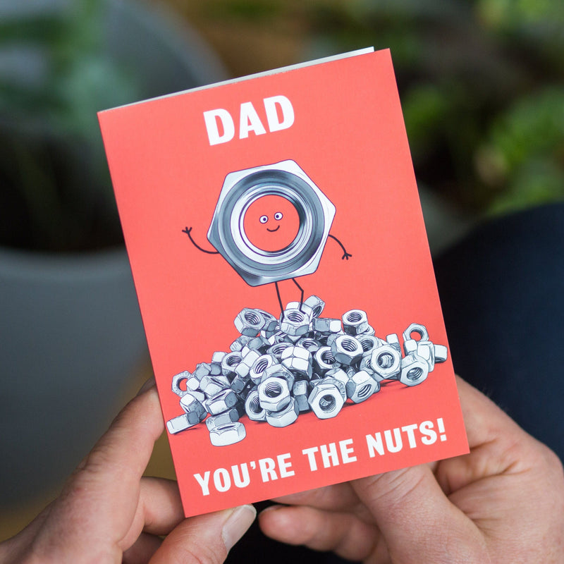 A cute card for Dad featuring an illustration of a pile of DIY fasteners and the words 'Dad You're The Nuts'