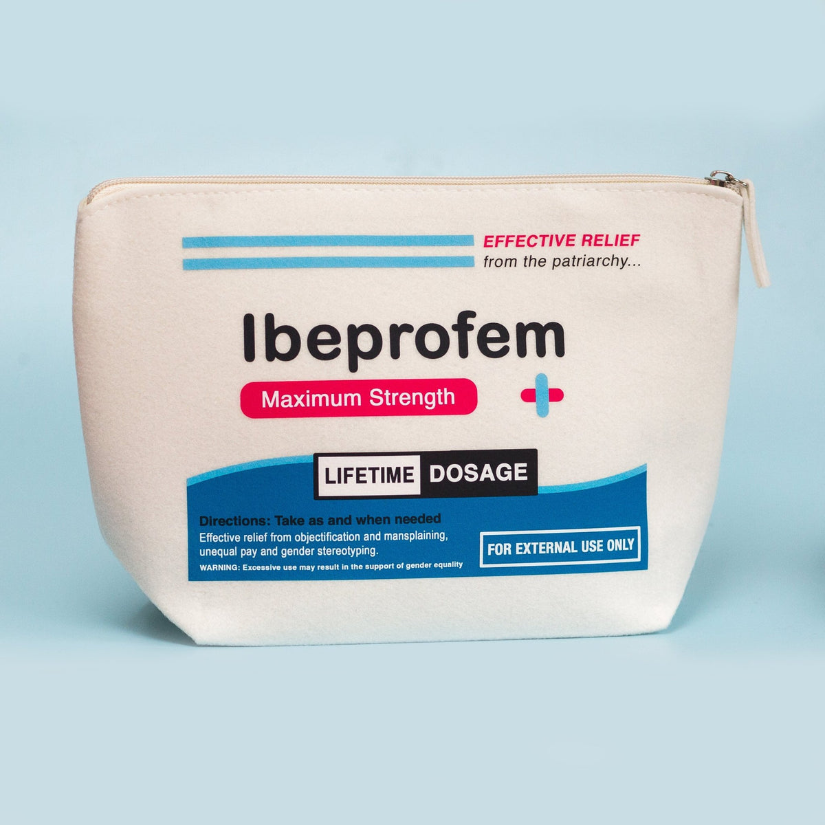An off-white canvas pouch with a printed Ibuprofen Maximum Strength label, photographed against a solid light blue background.