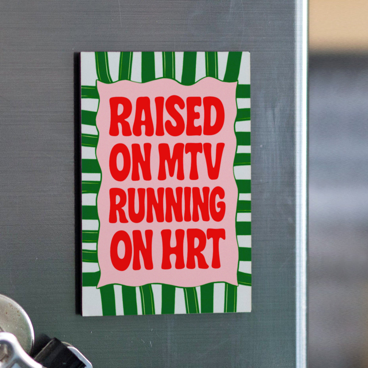 Fridge magnet with text 'Raised on MTV Running on HRT' on a striped background