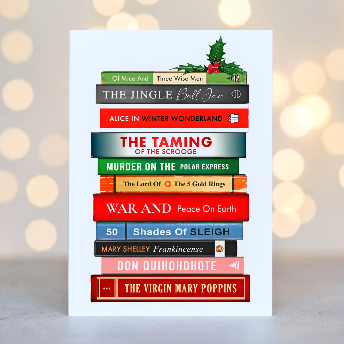 A christmas card featuring a stack of books with colourful book spines on a white background with blurred lights.