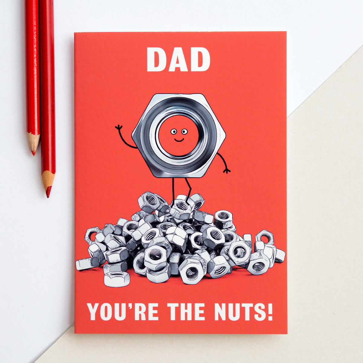 A card for Dad by Of Life & Lemons that says 'Dad You're The Nuts' and features an illustration of a pile of nuts and bolts
