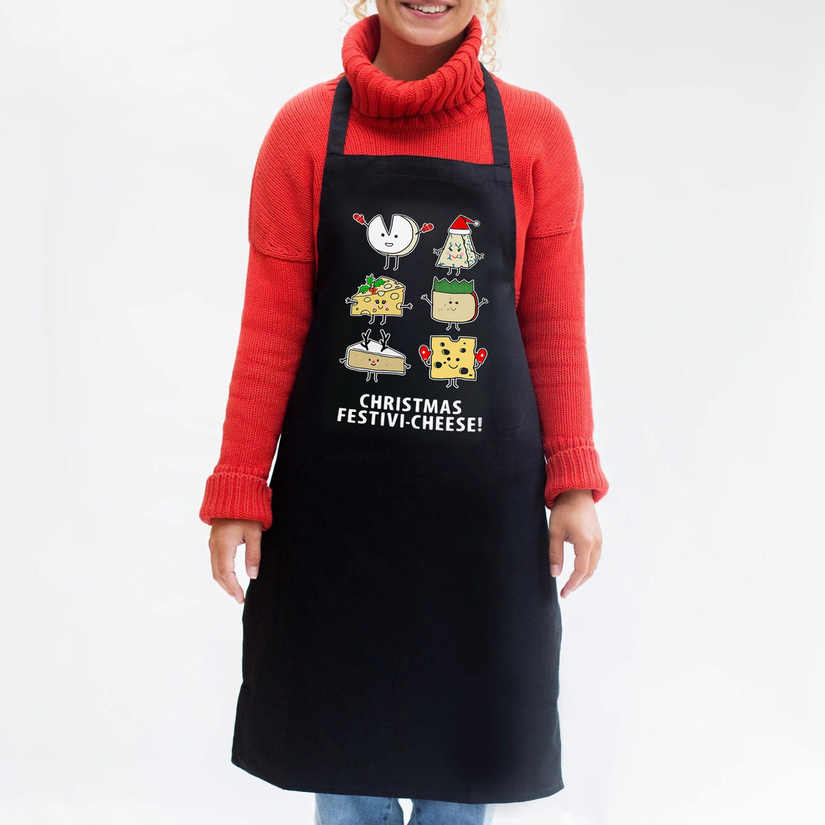 Person wearing a black apron with Christmas-themed cheese design and text, on a white background