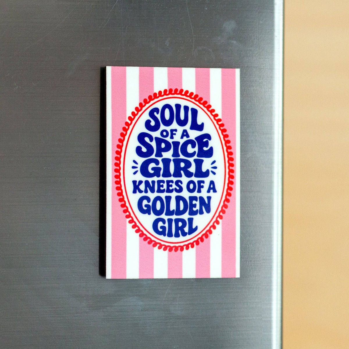 Striped fridge magnet with text design on a metallic surface