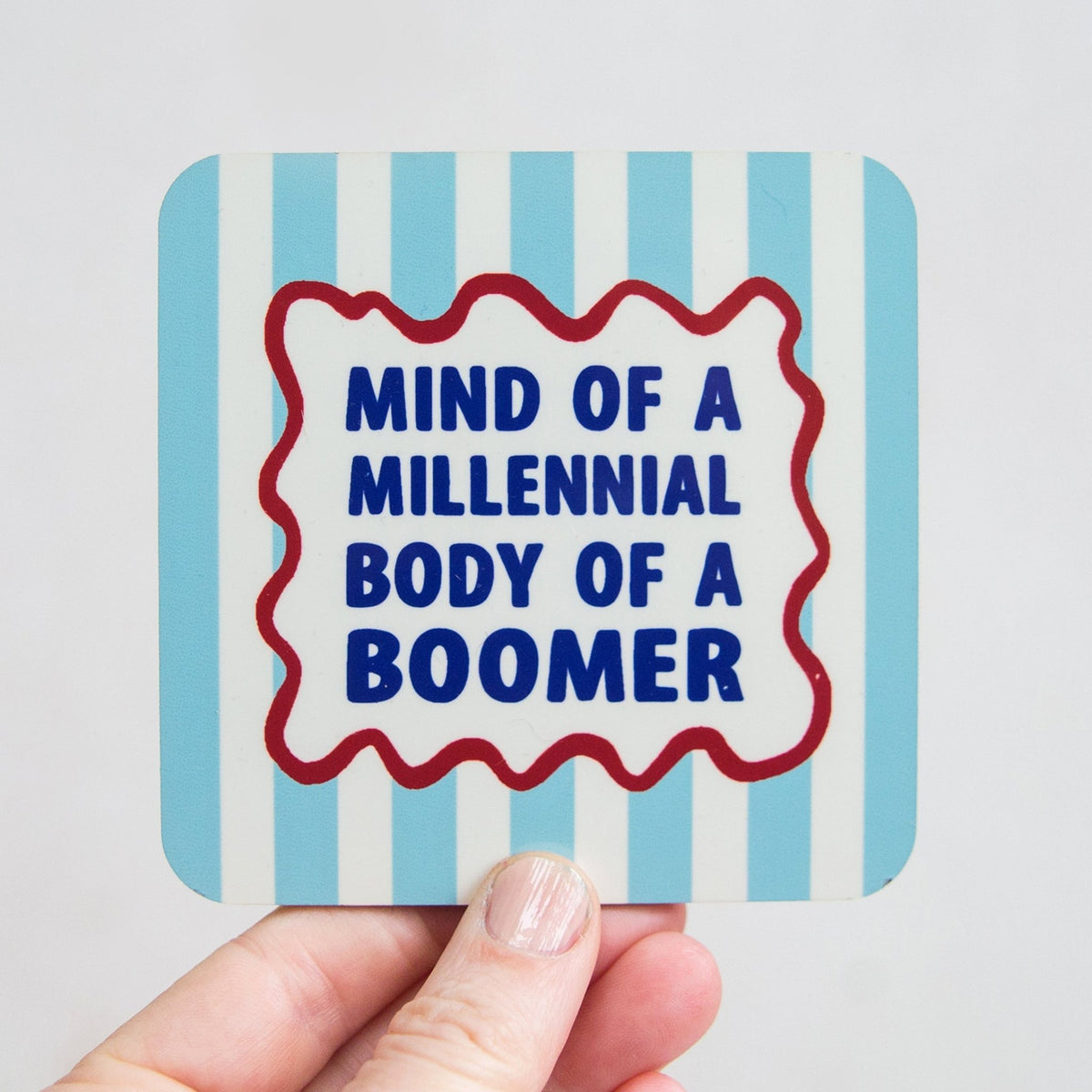Card with 'Mind of a Millennial Body of a Boomer' text on a blue striped background