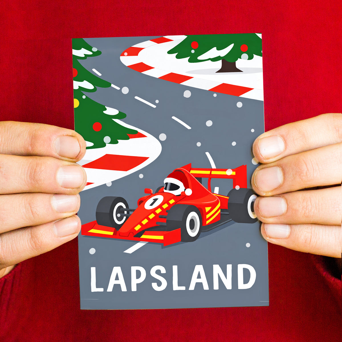 formula 1 themed christmas card featuring a festive looking racing car on a snowy race track and our funny pun 'Lapsland'.