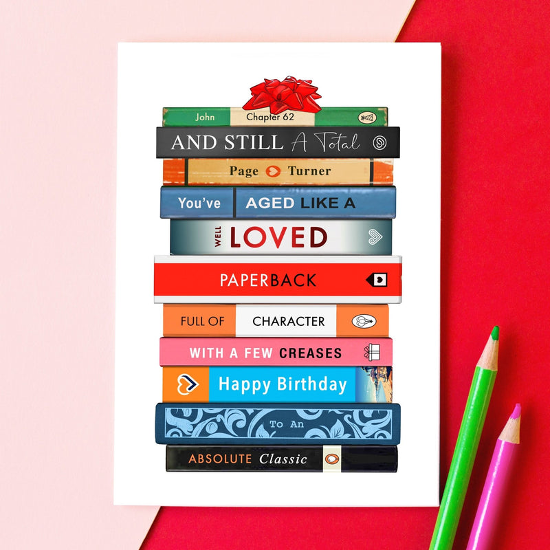 a personalised birthday card for book lovers featuring an illustration of a stack of books spelling out a literary themed birthday message