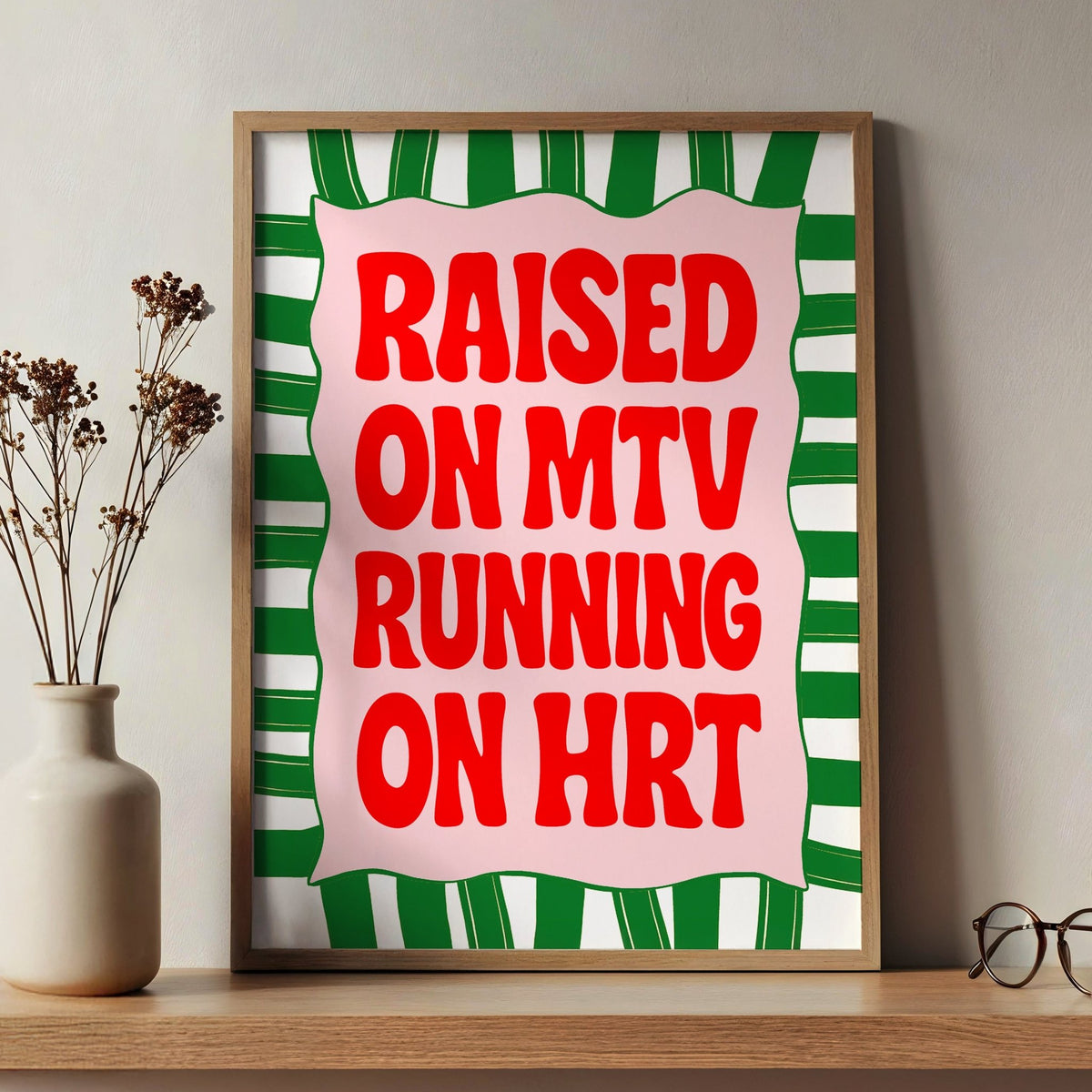 red and green slogan poster in a wooden frame on a shelf