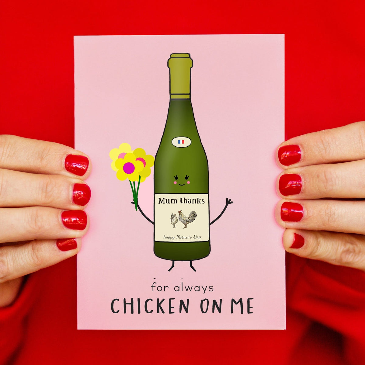 chicken wine mothers day card held in womens hands against a red background