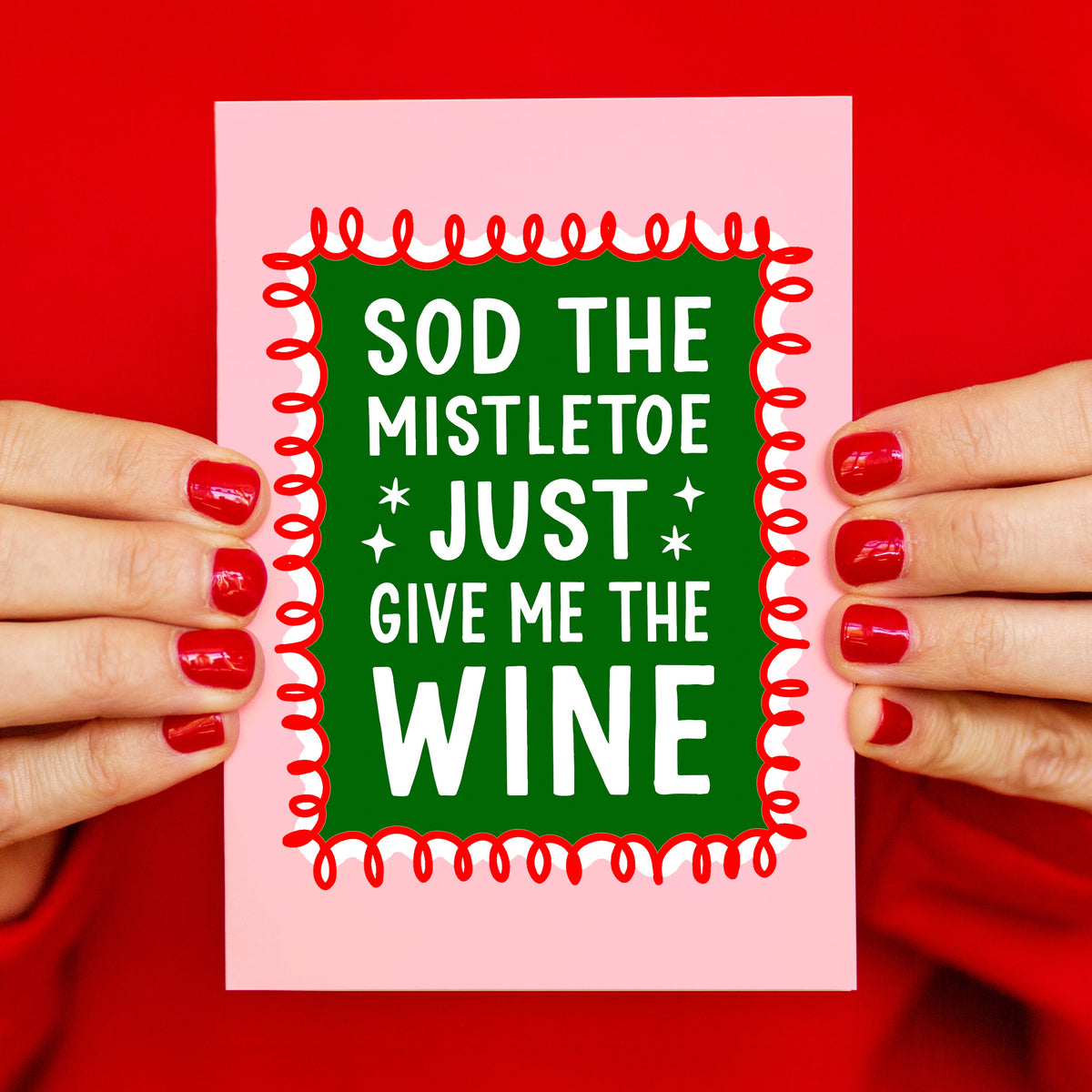 pink christmas card featuring a play on the song mistletoe and wine, instead saying sod the mistletoe, just give me the wine