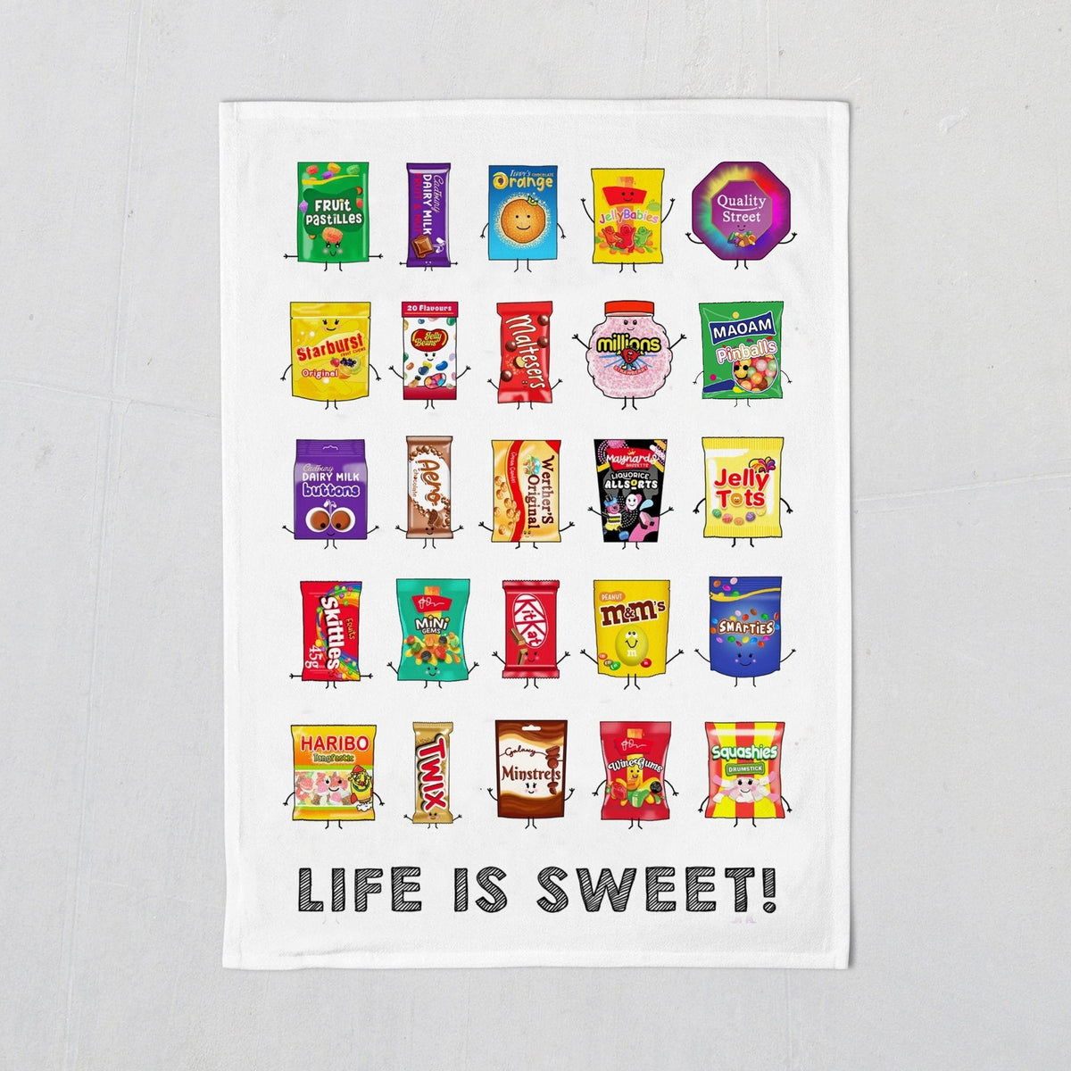 tea towel with illustrations of various candy packages and 'Life is Sweet!' text on a white background