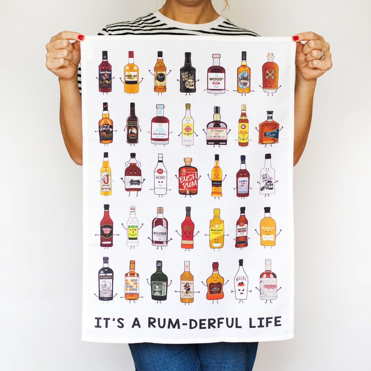 Person holding a poster with cartoon bottles of rum and the text 'It's a Rum-derful Life'.