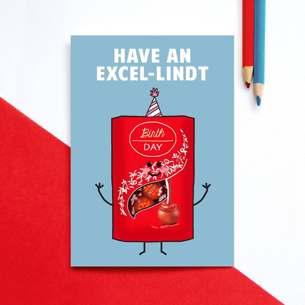 Birthday card with a red Lindt chocolate bar character on a blue background, with text 'Have an Excel-lindt Birthday'.