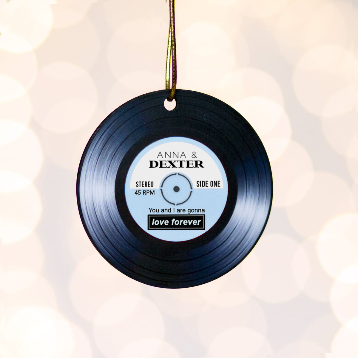 Vinyl record ornament with personalized text on a soft white background