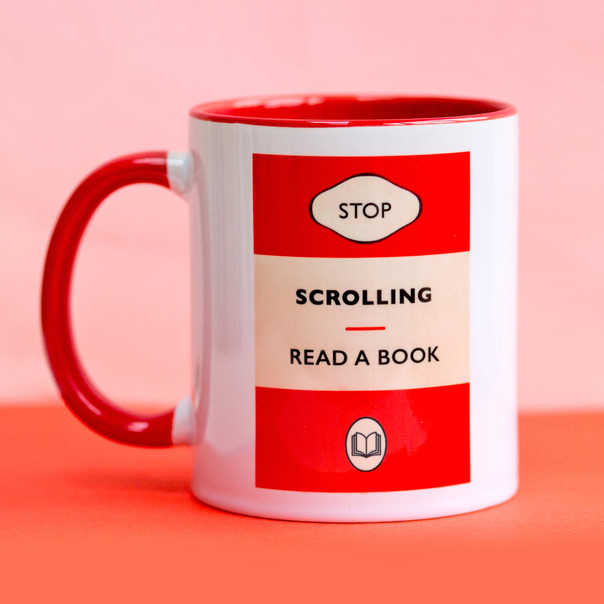 Mug with 'Stop Scrolling Read a Book' text on a pink background