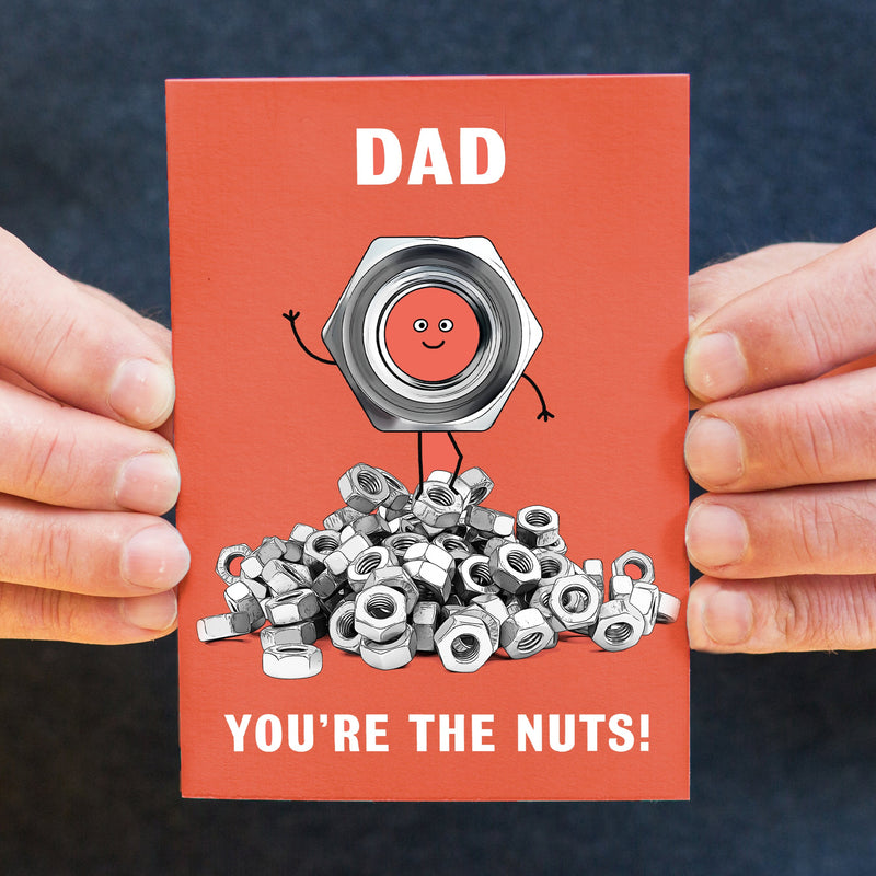 A cute card for Dad featuring an illustration of a pile of DIY fasteners and the words 'Dad You're The Nuts'