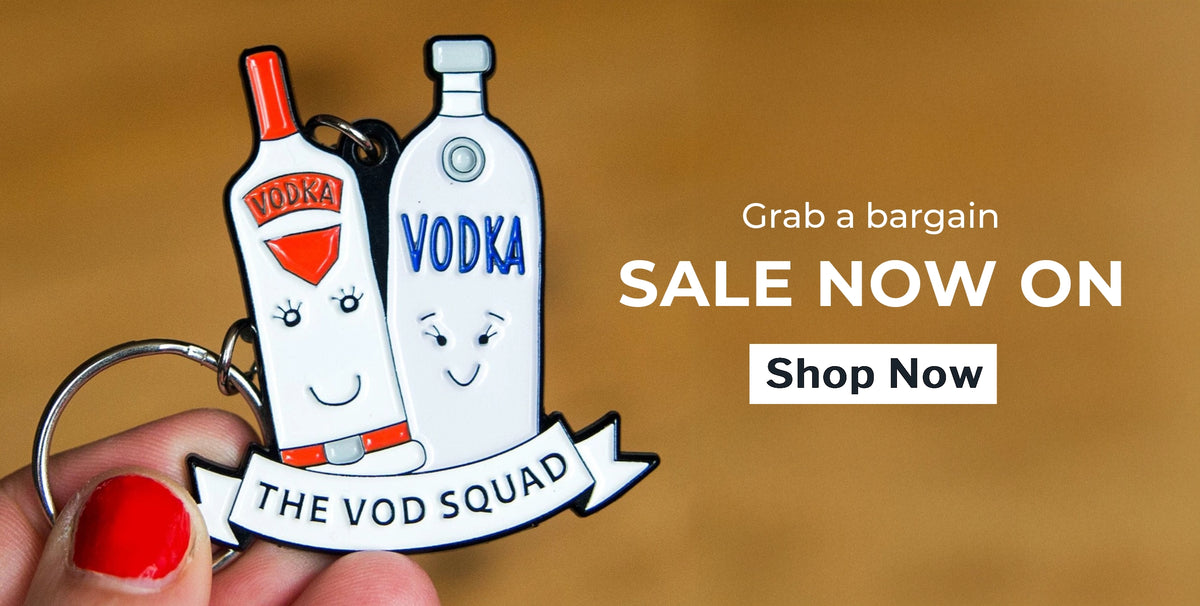 Vodka bottle keychain with cartoon faces held by a hand, on a brown background with sale text.