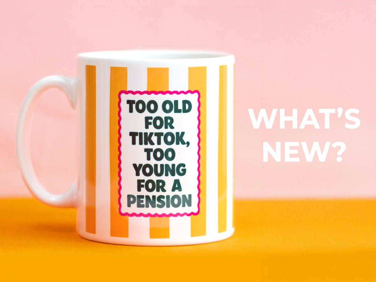 Mug with striped design and text on a pink and orange background