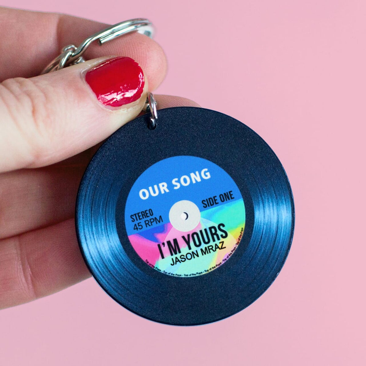 a personalised keyring designed to look like a vinyl record personalised with a song