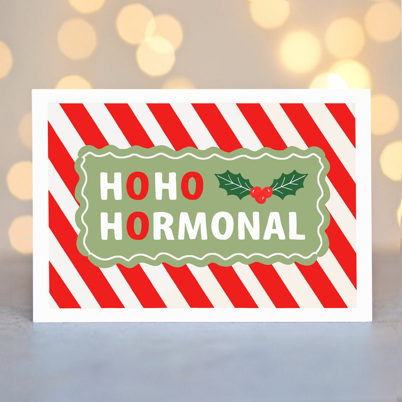 Holiday-themed card with 'HOHO HORMONAL' text on a striped background
