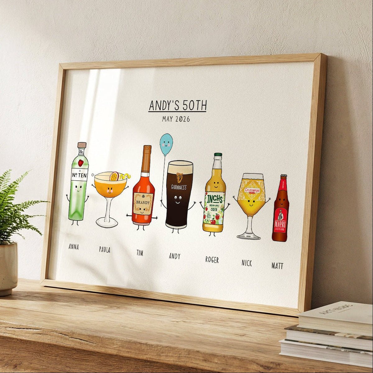 Framed artwork with cartoon drinks on a wooden surface