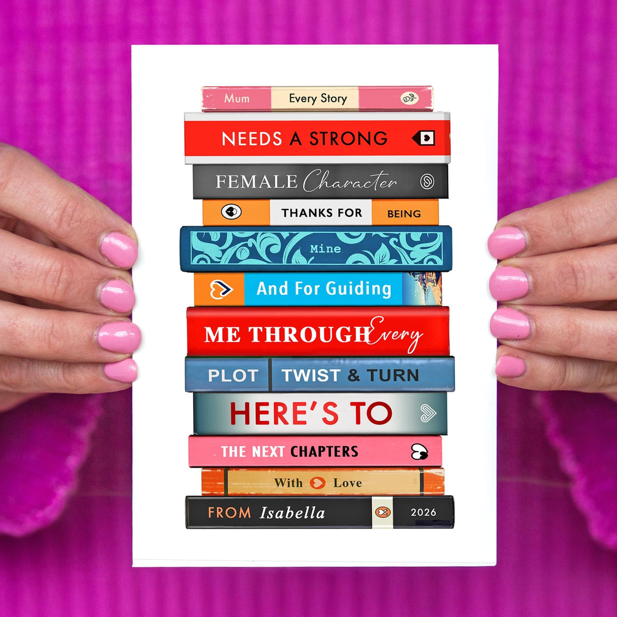 ladies hands holding a mothers day card featuring a stack of books