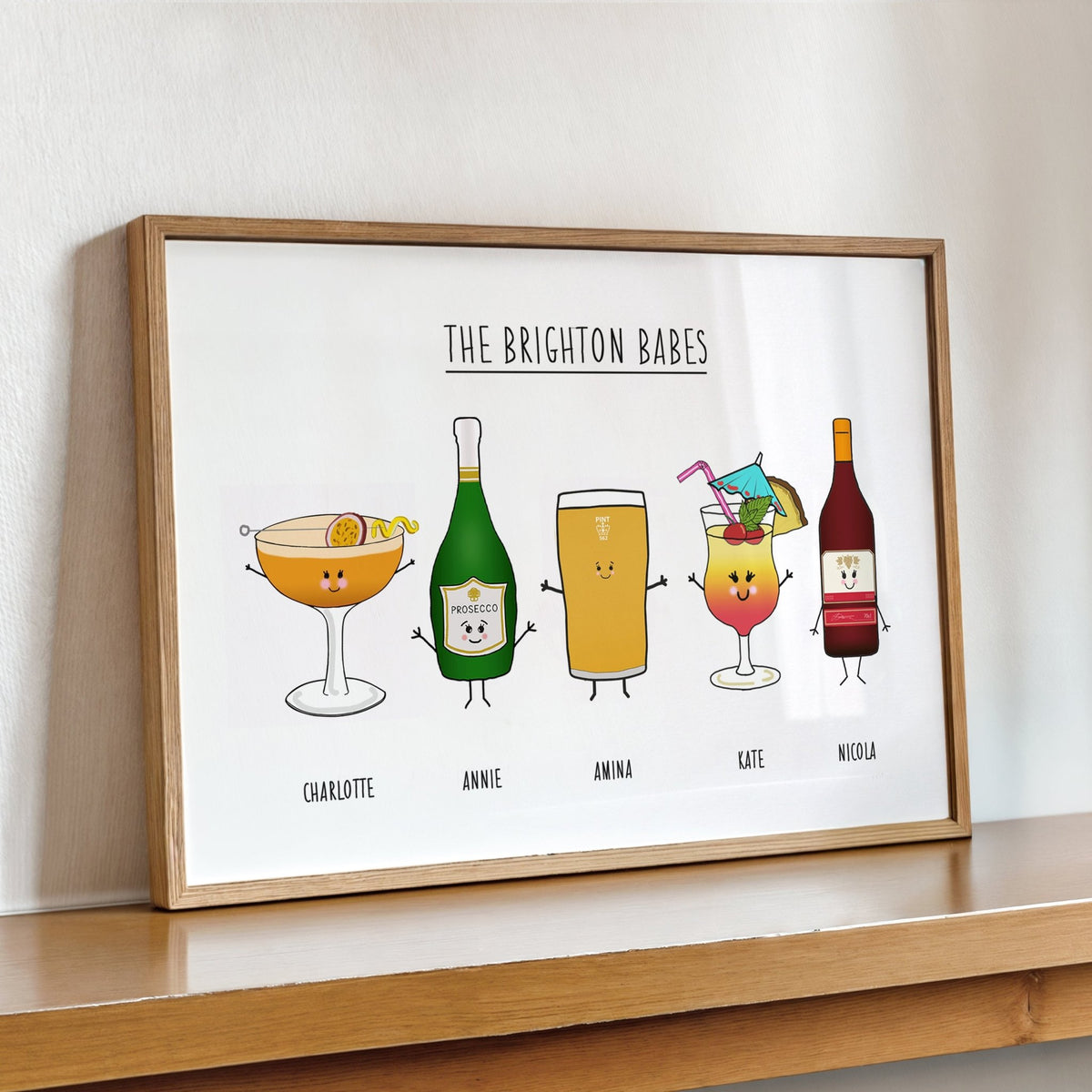 Framed artwork titled 'The Brighton Babes' featuring cartoon drinks on a white background.