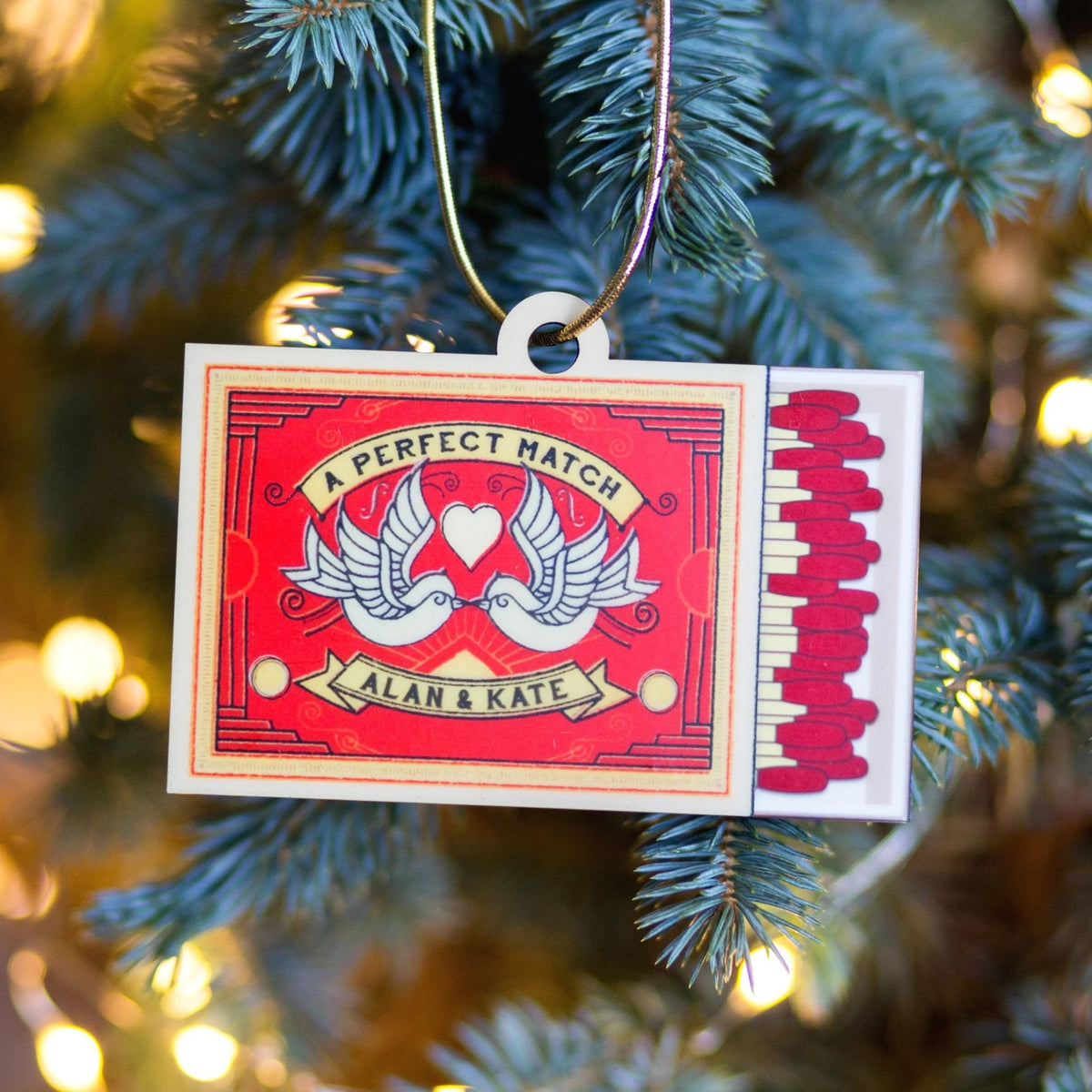 Matchbox ornament with personalized names on a Christmas tree