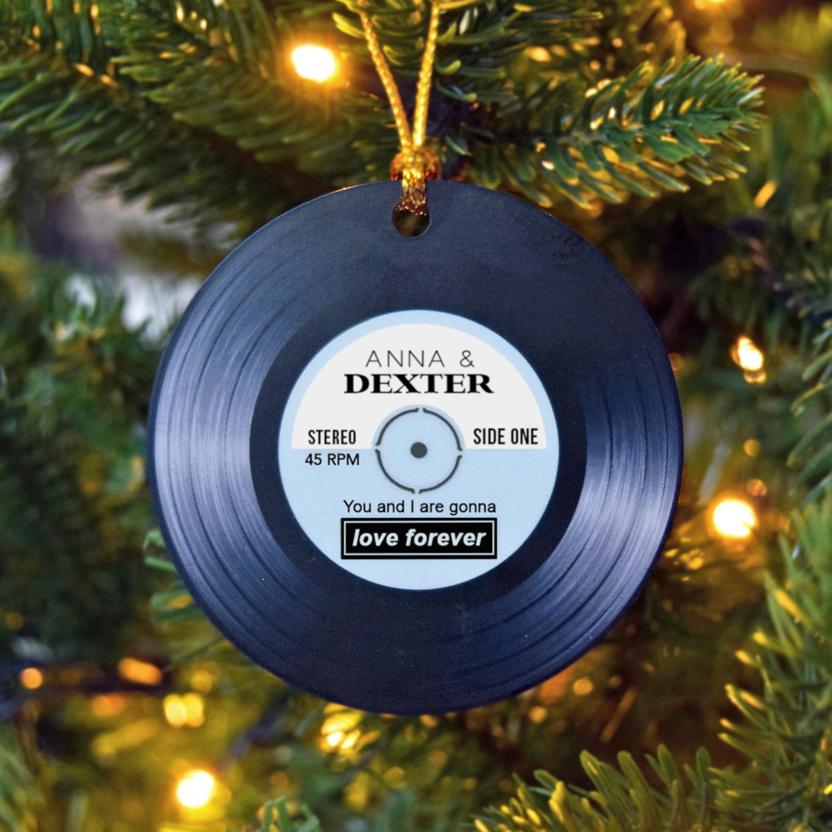 Vinyl record ornament with personalized text on a Christmas tree.