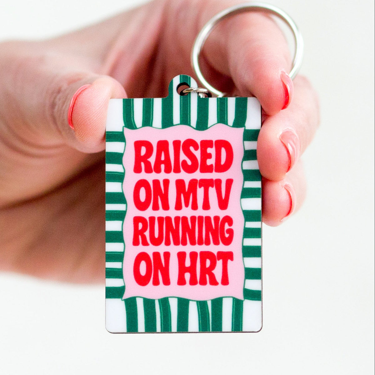 keyring with funny hrt slogan held in female hands