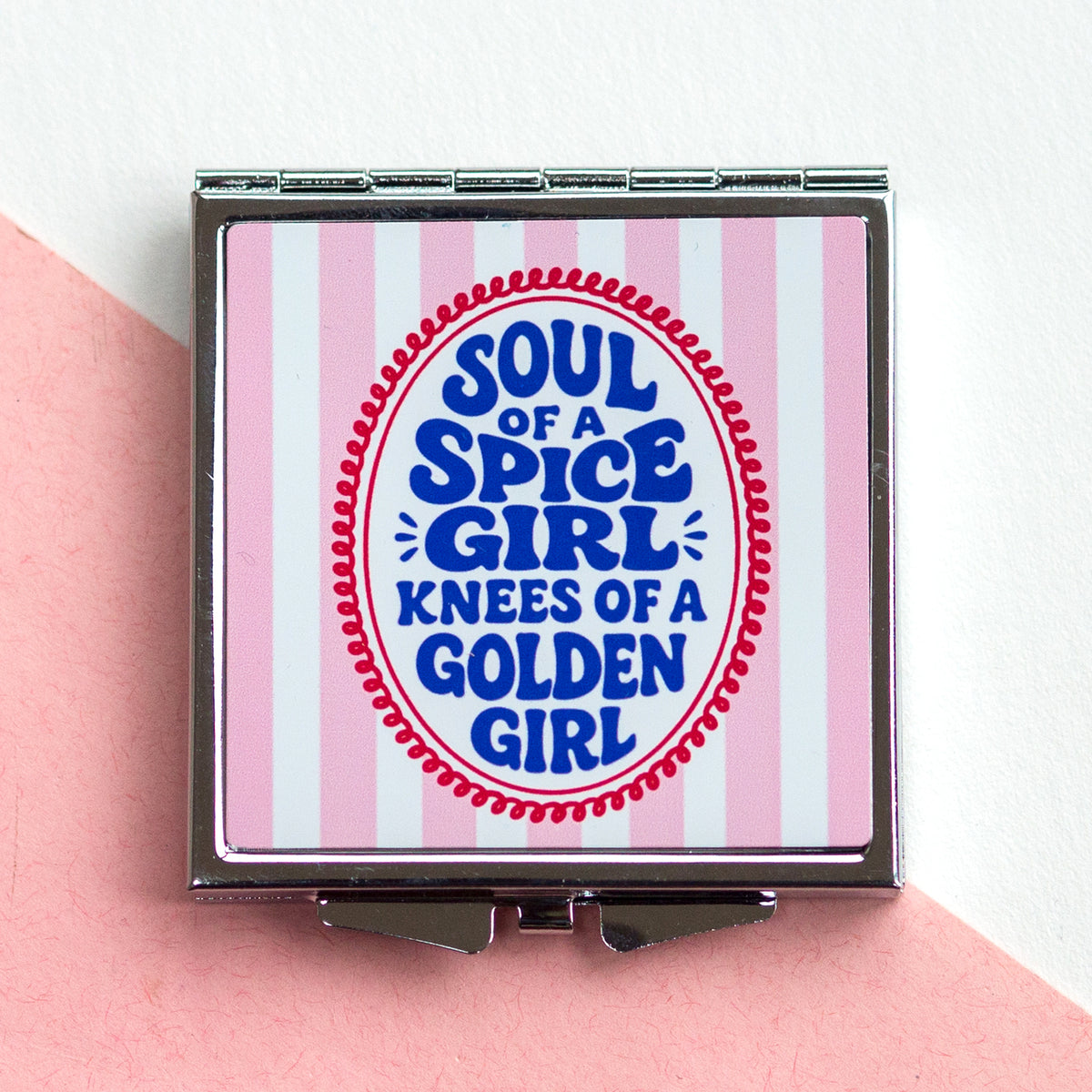 Compact mirror with 'Soul of a Spice Girl, Knees of a Golden Girl' text on a pink and white striped background.